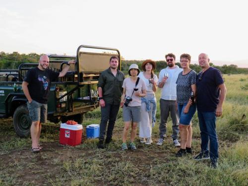 a group of people standing in front of a truck at The Baobab Bush Lodge and Villa in Hoedspruit