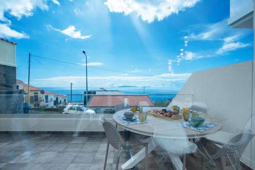 a table and chairs on a balcony with a view at CasaNova by LovelyStay in Santa Cruz