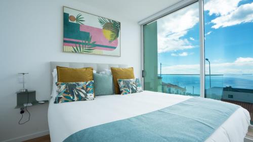 a bedroom with a large bed and a large window at CasaNova by LovelyStay in Santa Cruz