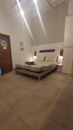 a bedroom with a bed in a white room at Amélie House in Marsala