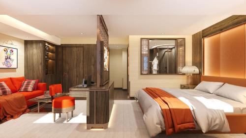 une chambre avec un lit et un salon dans l'établissement Maya Hôtel Courchevel 1850, à Courchevel