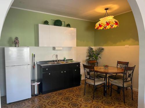 a kitchen with a table and a white refrigerator at 310Guest-House La Vida in San Juan
