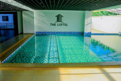 a swimming pool with a sign that reads the hotel at Idyllic nest ,studio apartment in Nairobi