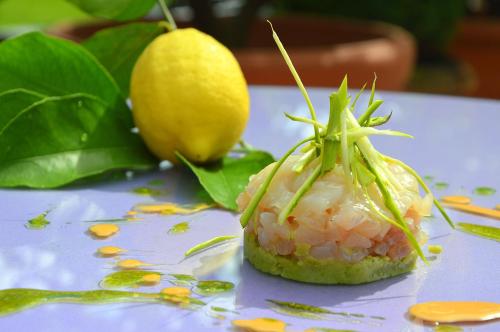 a piece of sushi on a plate with a lemon at Villa Abbazia Relais & Chateaux in Follina