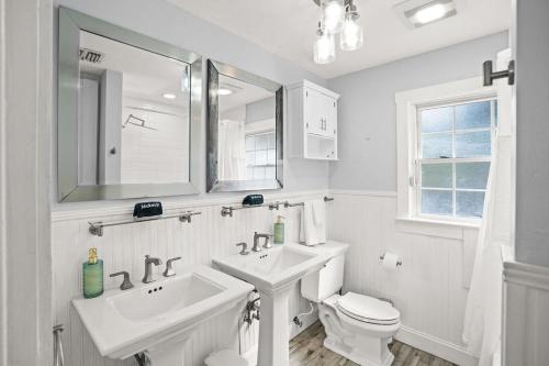 a white bathroom with a sink and a toilet at Heated Pool Grill Fire Pit & Cold Plunge Sleeps 8! in West Palm Beach
