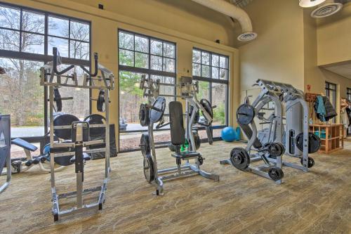 a gym with several tread machines in a room with windows at Lake and Golf Course Views Big Canoe Home with Deck! in Jasper