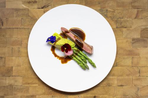 a white plate with food on top of a table at La Cordée des Alpes SUP in Verbier