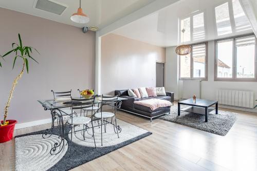 un salon avec un canapé et une table dans l'établissement Le Faubourg Saint Martin Senlis, à Senlis