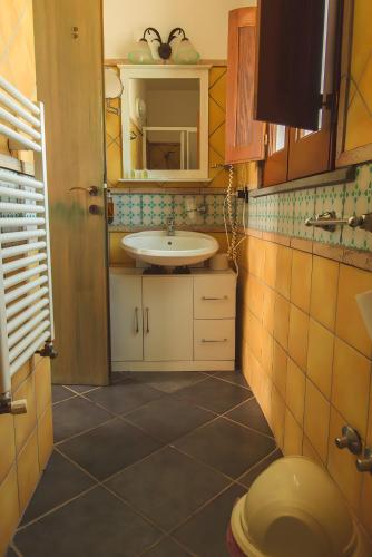 a bathroom with a sink and a toilet in it at Agriturismo Terrenia in Taormina