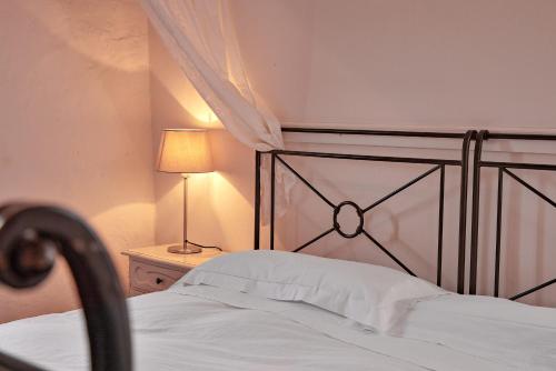 a bedroom with a bed and a lamp on a table at Agriturismo Canonica in Greve in Chianti