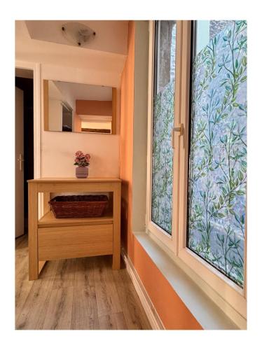 a window in a room with a table and a mirror at Logis 2 Caen in Caen
