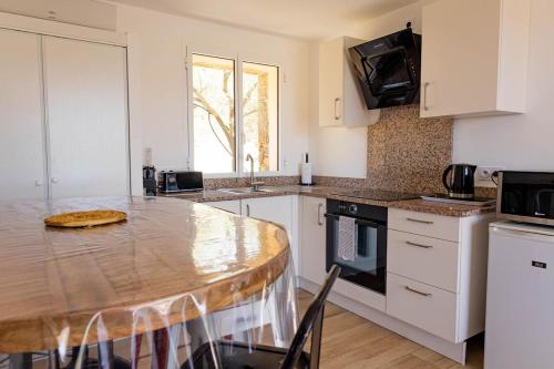 a kitchen with a table with a pizza on it at Domaine de Campu in Vallecalle