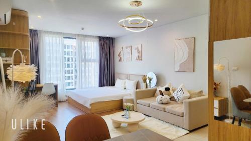 a living room with a bed and a couch at YLY Homestay Hạ Long in Ha Long