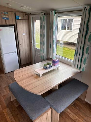 a kitchen with a wooden table and a refrigerator at Edinburgh, Seton Sands, The Fishing Boat in Port Seton