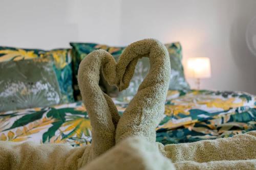 a pair of towel swans made out of a bed at Springfield Deer View - Private Hot Tub , 2 Dogs Max,Fishing Nearby & Communal Swimming Pool ,Shut for the winter open April 2026 in Cheriton Bishop