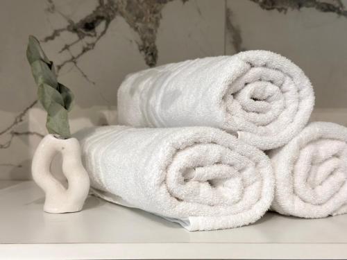 a pile of towels sitting on top of a shelf at Aquavista Residence - Lakeview Holiday Apartments with Pool in Dormelletto