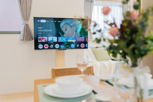 a living room with a table and a tv at Magazine Home Tokyo Spacious 93 3BR Skytree7 minutesAsakusa12 minutes by train in Tokyo