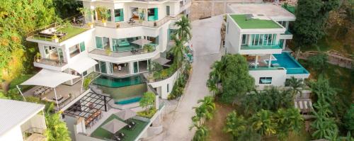 an aerial view of a large white house at Seaview 10 bedroom villa Bangtao beach area in Ban Thalat Choeng Thale