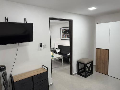 a living room with a flat screen tv on a wall at Casa Dushi Apartment in Oranjestad