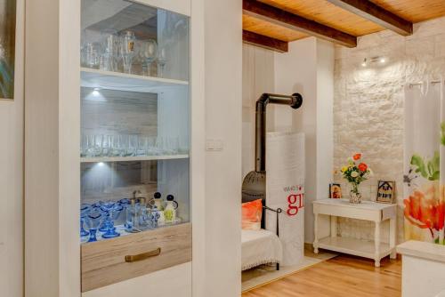 a room with a glass cabinet filled with blue glasses at Villa Pax in Kastel Stafilic