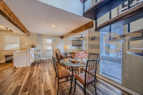 a kitchen and dining room with a table and chairs at Thornsberry Beach Loft in Lake Ozark