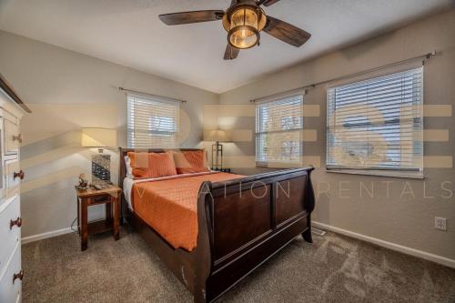 a bedroom with a bed and a ceiling fan at Thornsberry Beach Loft in Lake Ozark