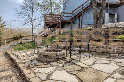 a patio with chairs and a fire pit in front of a building at Thornsberry Beach Loft in Lake Ozark