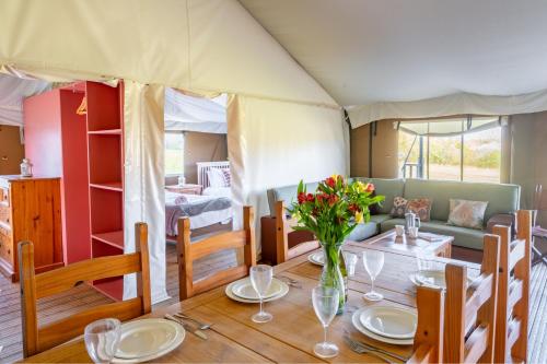 a dining room with a table in a tent at Kestrel - Sweffling Hall in Rendham
