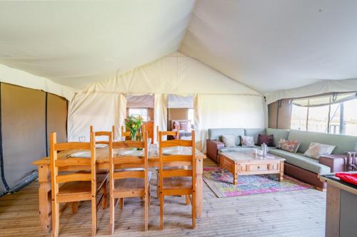 a dining room and living room with a tent at Kestrel - Sweffling Hall in Rendham