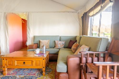 a living room with a couch and a table at Kestrel - Sweffling Hall in Rendham
