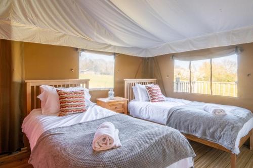 a bedroom with two beds and a window at Kestrel - Sweffling Hall in Rendham