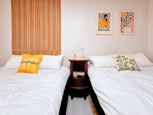 two beds sitting next to each other in a room at Private House Good Stay Samdeok in Daegu