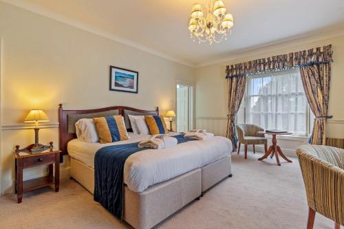 a bedroom with a large bed and a window at Best Western Lamphey Court Hotel and Spa in Lamphey