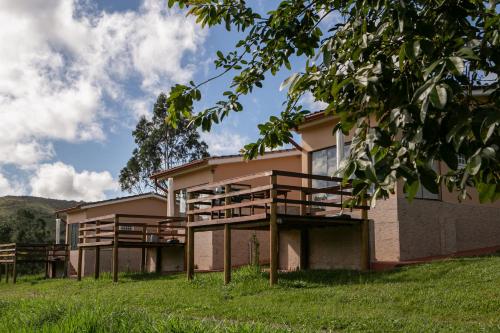 a building with wooden balconies on the side of it at Pousada e Chalés Passaredo Canastra in São Roque de Minas