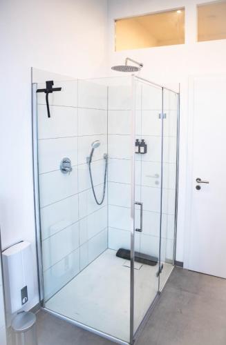 a shower with a glass door in a bathroom at Helles Apartment im Herzen Mönchengladbachs in Mönchengladbach