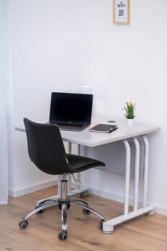 a white desk with a laptop computer on top of it at Helles Apartment im Herzen Mönchengladbachs in Mönchengladbach