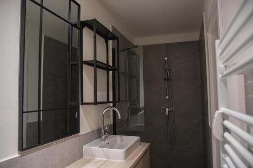 a bathroom with a sink and a shower at Capital Apartment in Nitra