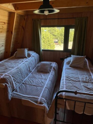 En eller flere senge i et værelse på Cabaña El Sauce Estilo Nordico en Villa Meliquina Neuquen