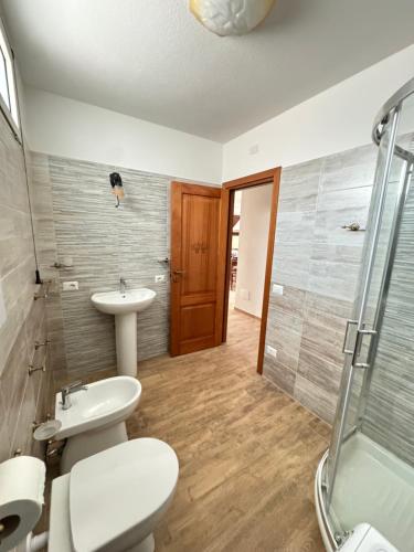 a bathroom with two sinks and a shower at Budoni residence Lutturai 4 in Budoni