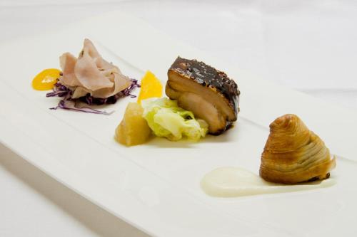 a white plate topped with different types of food at Villa Abbazia Relais & Chateaux in Follina