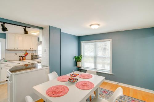 a kitchen and dining room with a white table and chairs at Trail Access Berkshires Gem with Rooftop Deck! in Lee