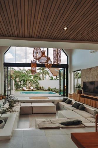 a living room with a couch and a swimming pool at abode II Zanzibar in Paje