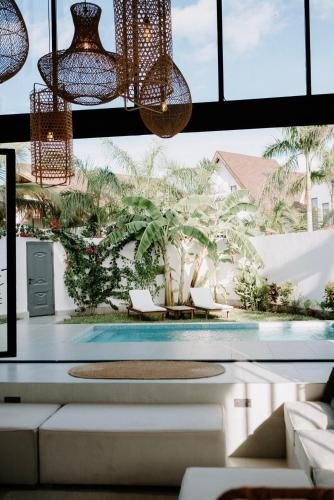 a room with a pool and chandeliers at abode II Zanzibar in Paje