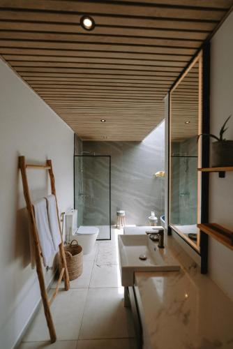 a bathroom with a sink and a toilet at abode II Zanzibar in Paje