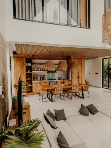 a kitchen and dining room with a table and chairs at abode II Zanzibar in Paje