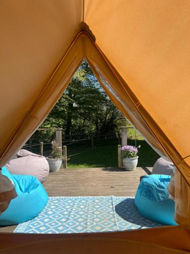 a tent with two bean bags inside of it at Swallows Oast Glamping in Sedlescombe