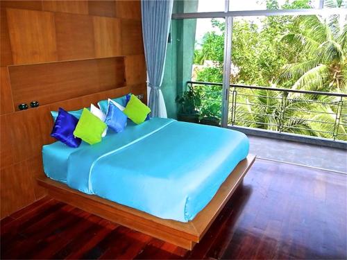 a bed in a room with a large window at Eva Villa Rawai 3 bedrooms Private Pool in Rawai Beach