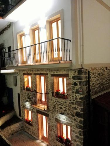 a building with a staircase with windows and a balcony at El Patio de Vespasiano- San Juan- vistas al ayuntamiento junto al puerto in Castro-Urdiales
