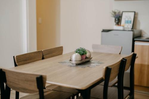 a wooden table with a plant on top of it at NEW! Trendy 1BR in Cebu IT Park- Central location in Cebu City