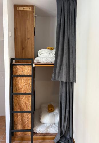 a room with two bunk beds and a curtain at Spanglish Hostel Benidorm in Benidorm